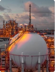 Industrial plant storage facility at sunset